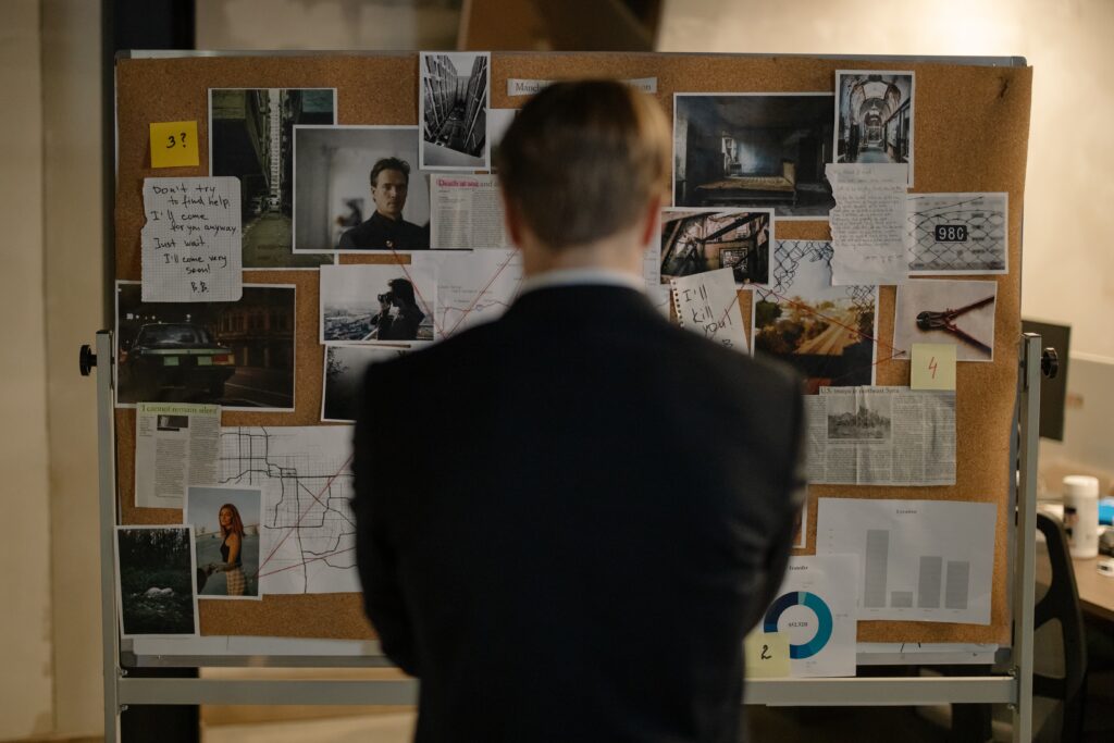 private investigator looking at the pin board